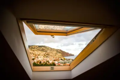 a window in a room with a view of a city at CBA Suites Madeira in Funchal