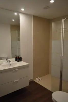 a bathroom with a sink and a shower at CBA Suites Madeira in Funchal