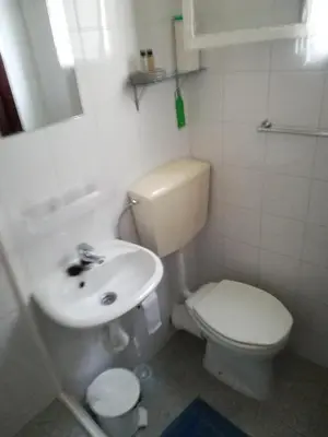 a small bathroom with a toilet and a sink at Charming Studio in Funchal with a Lovely Terrace – 20 m² in Funchal