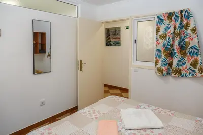 a small bedroom with a bed and a window at Residencia ANA Piso Zero 0 in Santa Cruz