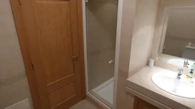 a bathroom with a shower and a sink and a mirror at LakeView Boavista in Lagos