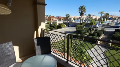 a balcony with two chairs and a view of a street at LakeView Boavista in Lagos