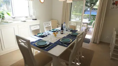 a dining room table with a blue and white table cloth at LakeView Boavista in Lagos