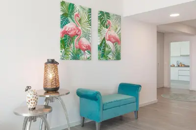 a living room with a blue chair and a table at Getaway to Blue Paradise at Madeira Island in Funchal