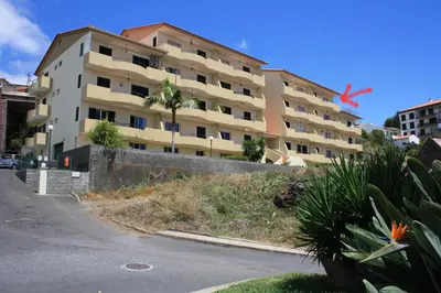a large apartment building on the side of a street at Vista Mar in Caniço