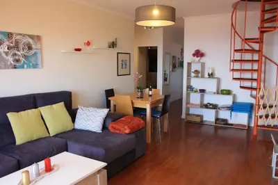 a living room with a couch and a table at Vista Mar in Caniço