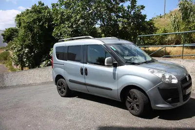 a white van parked in a parking lot at Vista Mar in Caniço
