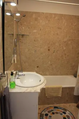 a bathroom with a sink and a bath tub at Vista Mar in Caniço