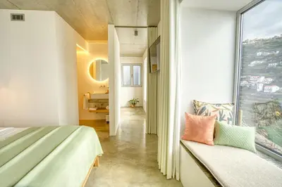 a bedroom with a bed and a window at Socalco Nature Calheta in Calheta