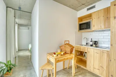a kitchen with a wooden table and a sink at Socalco Nature Calheta in Calheta
