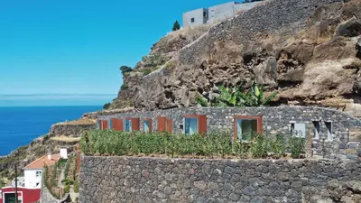 a house on the side of a mountain at Socalco Nature Calheta in Calheta