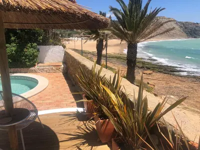 a resort with a swimming pool and a beach at Beach front/waterside apartment in Luz
