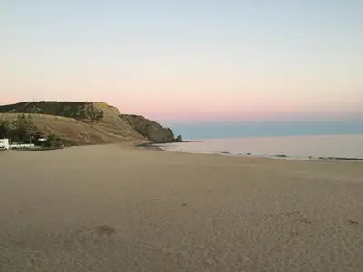 a view of a beach with a cliff at Beach front/waterside apartment in Luz