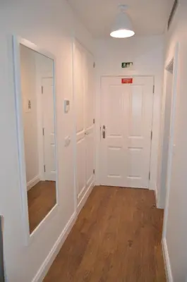 an empty hallway with a mirror and a door at Edificio Charles 202 in Funchal