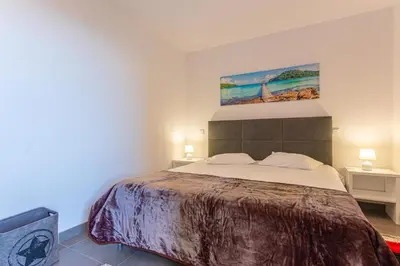 a bedroom with a bed and a painting on the wall at Flowers Island house 2 in Funchal
