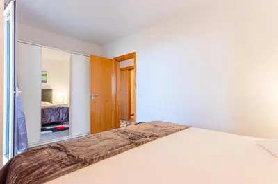 a bedroom with a bed and a mirror at Flowers Island house 2 in Funchal