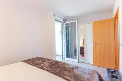 a bedroom with a bed and a sliding glass door at Flowers Island house 2 in Funchal