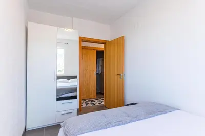 a bedroom with a bed and a closet and a mirror at Flowers Island house 2 in Funchal