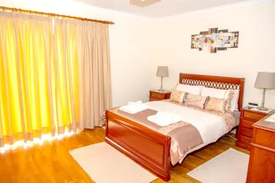 a bedroom with a bed and a yellow curtain at Charming house in Santa Cruz with sea view in Santa Cruz