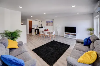 a living room with a couch and a table at SEAFRONT LUZ APARTMENT in Luz