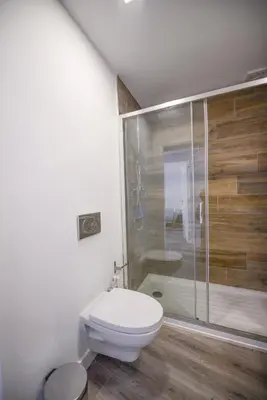 a bathroom with a toilet and a shower at SEAFRONT LUZ APARTMENT in Luz