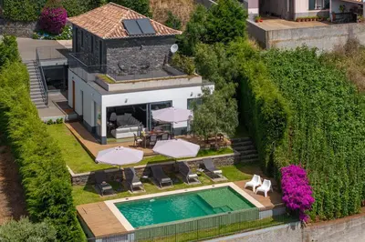 an aerial view of a house with a swimming pool at OurMadeira - Bella Vita in Calheta