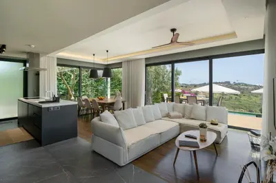 a living room with a white couch and a table at OurMadeira - Bella Vita in Calheta