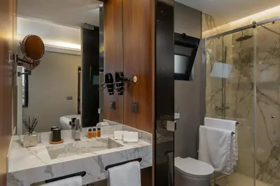 a bathroom with a sink and a toilet and a shower at OurMadeira - Bella Vita in Calheta