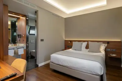 a bedroom with a large bed and a bathroom at OurMadeira - Bella Vita in Calheta