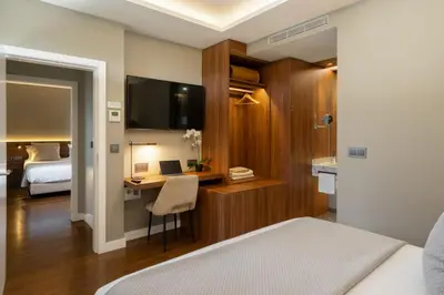 a bedroom with a bed and a desk with a laptop at OurMadeira - Bella Vita in Calheta