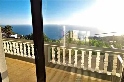 a balcony with a view of the ocean at Arcos Grands Suites with enormous and private pool. in Arco da Calheta