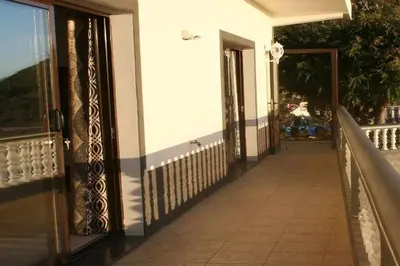 an open door of a building with a porch at Arcos Grands Suites with enormous and private pool. in Arco da Calheta