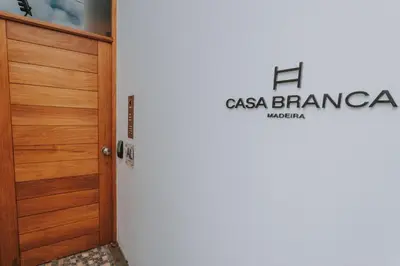 a door to a room with a logo on the wall at FLH Casa Branca Madeira in Funchal