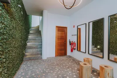 a hallway with stairs and a green wall at FLH Casa Branca Madeira in Funchal