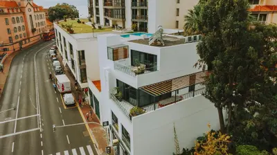 an aerial view of a white building on a street at FLH Casa Branca Madeira in Funchal