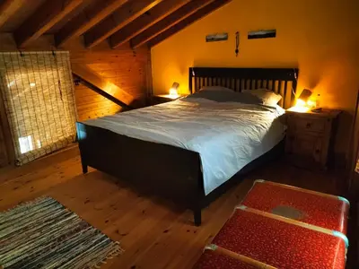 a bedroom with a large bed and a wooden ceiling at chabouco 2 (Mien) in Aljezur