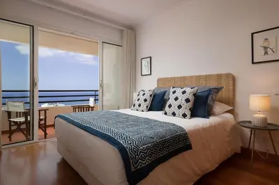 a bedroom with a bed with a view of the ocean at Vista Monumental by LovelyStay in Funchal