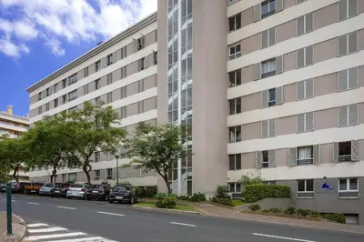 a large building with cars parked in front of it at Vista Monumental by LovelyStay in Funchal