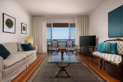 a living room with a couch and chairs and a television at Vista Monumental by LovelyStay in Funchal