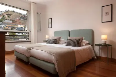a bedroom with a large bed with a large window at Vista Monumental by LovelyStay in Funchal