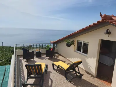 a balcony with chairs and a view of the ocean at Tabua Village Madeira Suite 5 Nature Lovers in Ribeira Brava