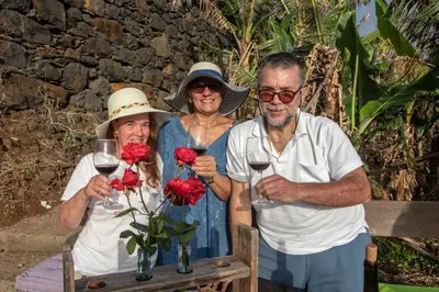 a group of three people holding glasses of wine at Tabua Village Madeira Suite 5 Nature Lovers in Ribeira Brava