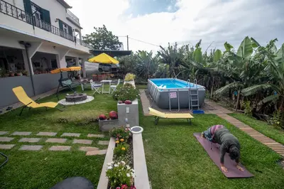 a backyard with a swimming pool and a house at Tabua Village Madeira Suite 5 Nature Lovers in Ribeira Brava