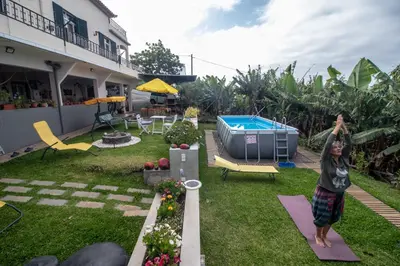 a woman standing on yoga mats in a backyard at Tabua Village Madeira Suite 5 Nature Lovers in Ribeira Brava