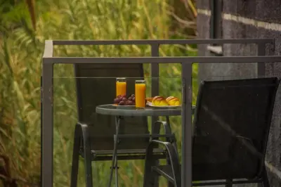 a table with fruit and two glasses of orange juice at Amoreira House in Calheta