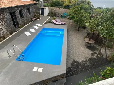 a swimming pool in the backyard of a house at Cottage Quinze & Apartment with Swimming pool in Ponta Delgada