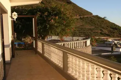 a balcony of a house with a white fence at Arcos Grand Suites with pool in Calheta