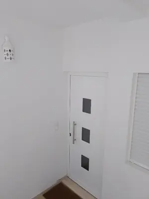 a white room with a door and a window at Casa Florival in Burgau
