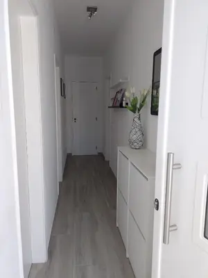 a hallway with white walls and wooden floors at Casa Florival in Burgau