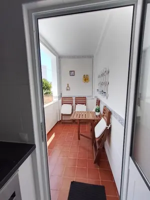 a view of a room with a table and chairs at Casa Florival in Burgau